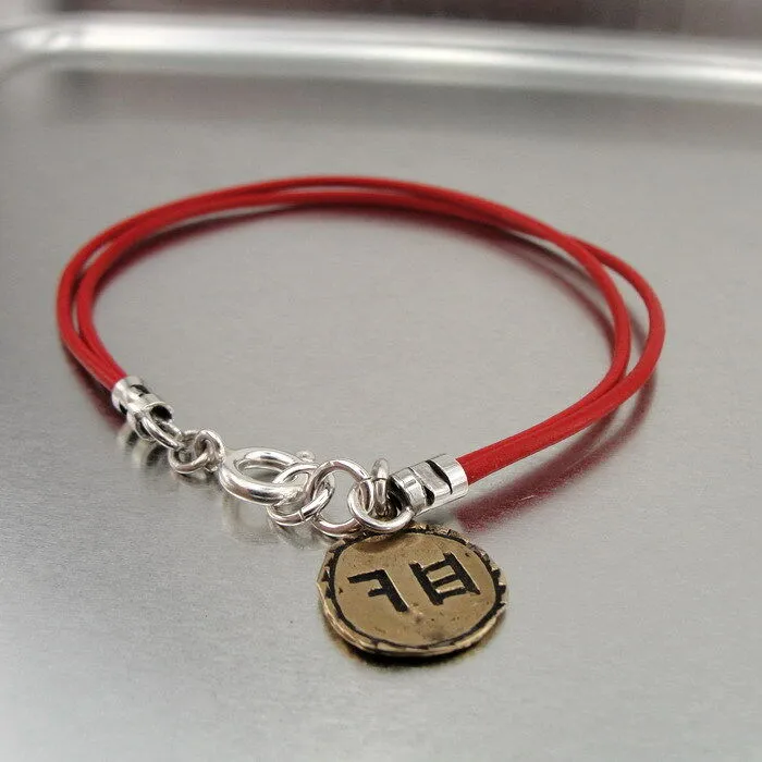 Hadar Designers Yng Leather bracelet brass charm, Ancient Hebrew script Chai (as