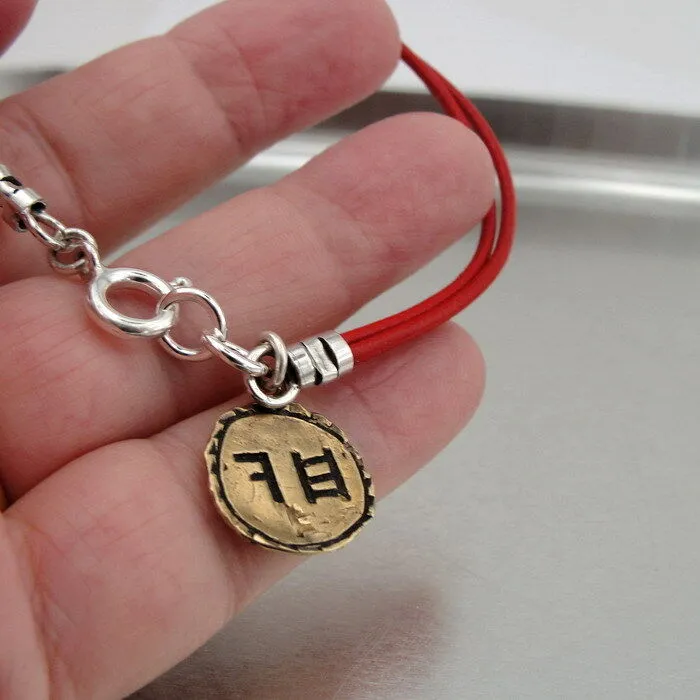 Hadar Designers Yng Leather bracelet brass charm, Ancient Hebrew script Chai (as