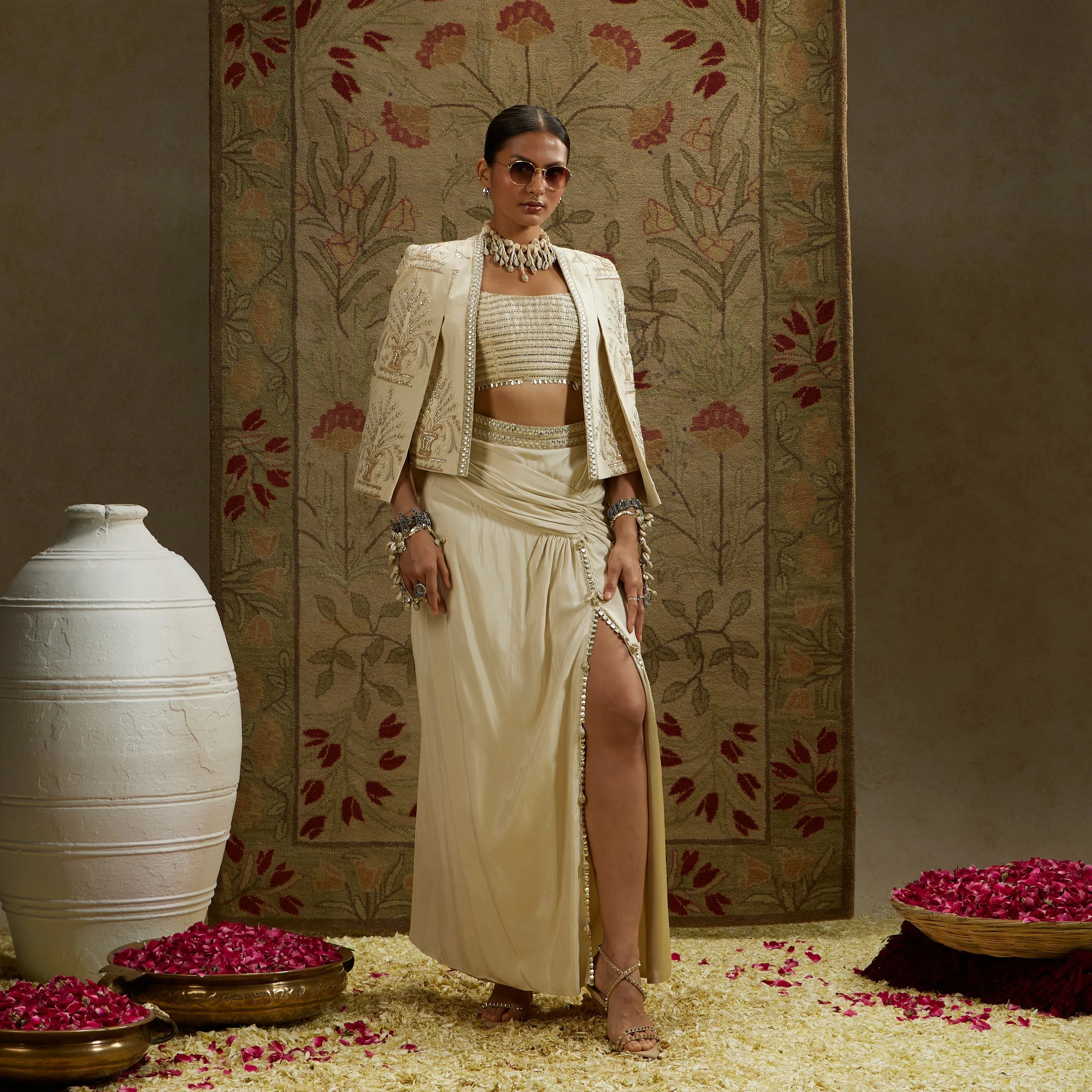 MAGNOLIA EMBELLISHED BUTTA CAPE JACKET PAIRED WITH METAL EMBELLISHED BUSTIER AND SLIT SKIRT